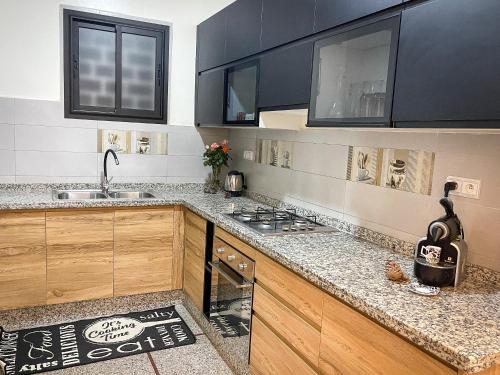 a kitchen with a sink and a stove top oven at Appartement la gare Rabat ville in Rabat