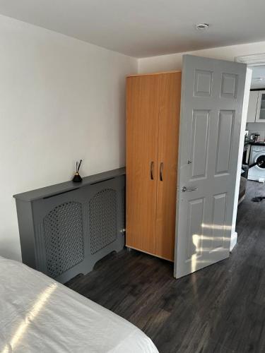 a bedroom with a bed and a closet and a door at The lovely apartment in London