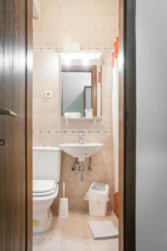 a bathroom with a toilet and a sink and a mirror at Prenočište Villa Ivanić in Josipovac