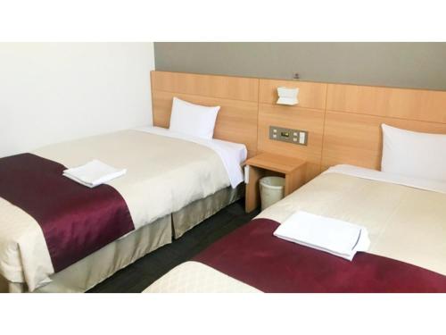 a hotel room with two beds with towels on them at Hotel Sunrise Choshi - Vacation STAY 73479v in Choshi