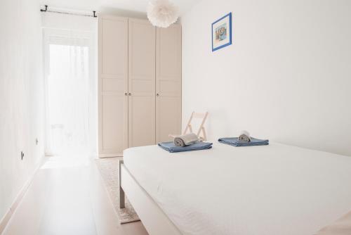 a white room with a bed and a window at Apartment Vito in Omiš