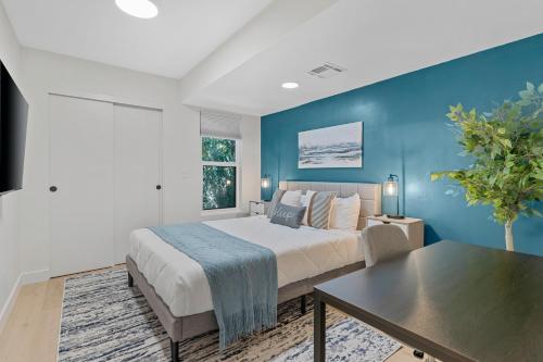 a bedroom with a bed and a blue wall at Peaceful Phoenix Getaway - Central Location, Family-Friendly & Pool Table! in Phoenix