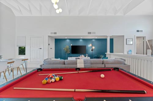 a living room with a red pool table at Peaceful Phoenix Getaway - Central Location, Family-Friendly & Pool Table! in Phoenix