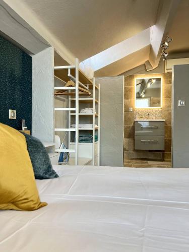 a bedroom with a large white bed and a tv at Hotel La Calanque in Mandelieu-la-Napoule