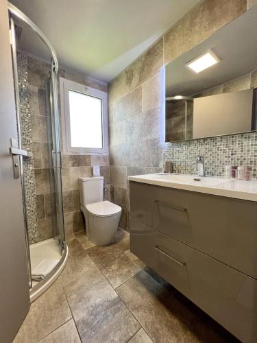 a bathroom with a toilet and a sink and a shower at Hotel La Calanque in Mandelieu-la-Napoule