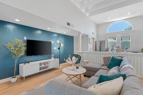 a living room with a couch and a tv at Peaceful Phoenix Getaway - Central Location, Family-Friendly & Pool Table! in Phoenix
