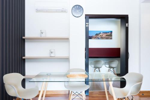 a dining room with a glass table and chairs at Feel Belgrade Apartments in Belgrade