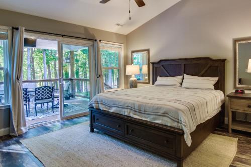 a bedroom with a large bed and a balcony at Anderson Lakefront Vacation Rental with Boat Dock! in Anderson