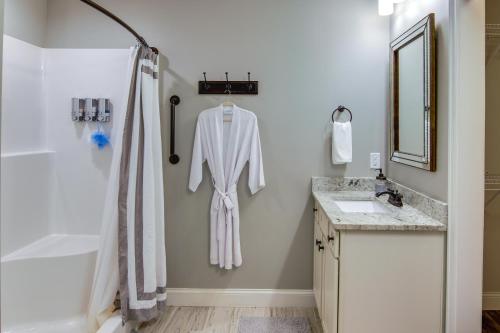 a white bathroom with a shower and a sink at Anderson Lakefront Vacation Rental with Boat Dock! in Anderson
