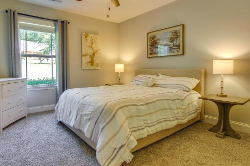 a bedroom with a bed with two lamps and a window at Anderson Lakefront Vacation Rental with Dock in Anderson