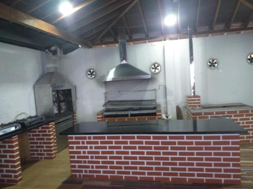 a kitchen with a brick counter and a stove at CABAÑA MANANTIAL DE DIOS in Turbo