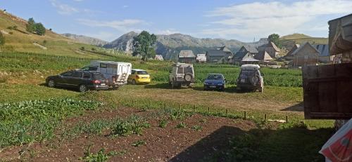 a group of vehicles parked in a field at Na krovu svijeta in Lukomir