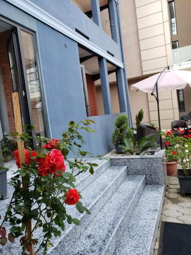 a group of flowers sitting on the steps of a building at MIDIA Guest House in K'obulet'i