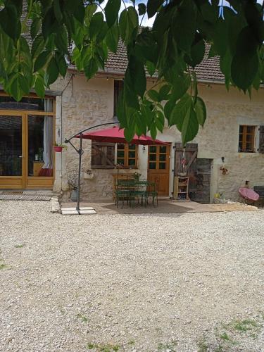 a house with a patio and a table at chez Karine in Ceyzérieu