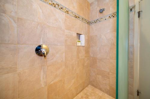 a bathroom with a shower with a glass door at Kapalua Villas Maui in Lahaina