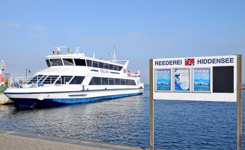 a large boat is docked in the water with a sign at Ferienwohnungen Udars auf Rügen in Udars