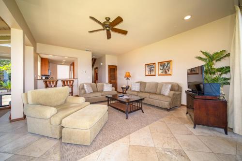 a living room with couches and a ceiling fan at Kapalua Villas Maui in Lahaina