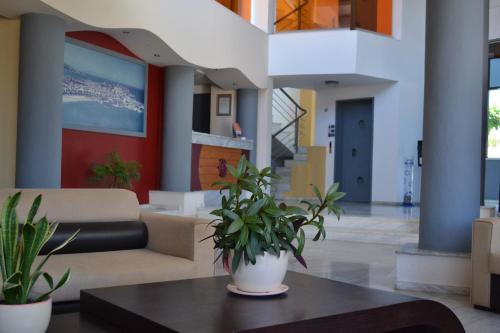 a lobby with a couch and a table with plants at Palladion in Adelianos Kampos