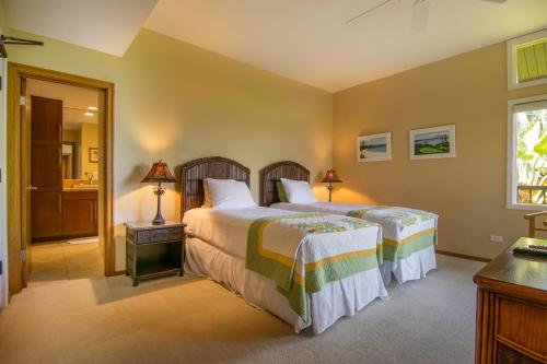 a bedroom with two beds and a window at Kapalua Villas Maui in Lahaina