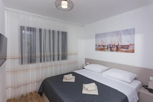 Posteľ alebo postele v izbe v ubytovaní Apartman Solis
