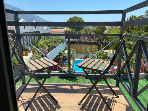 a balcony with a bench and a swimming pool at On Oda Oludeniz in Oludeniz