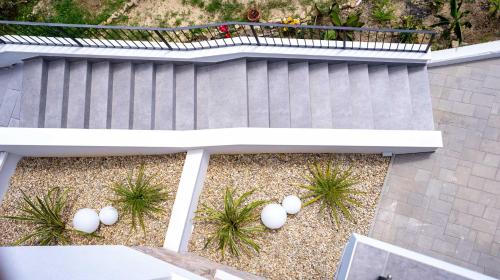 an overhead view of a porch with a bench and plants at Panorama Suite Dora with Jacuzzi in Palit