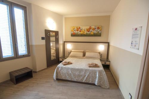 Postel nebo postele na pokoji v ubytování Guesthouse Buonarroti Florence