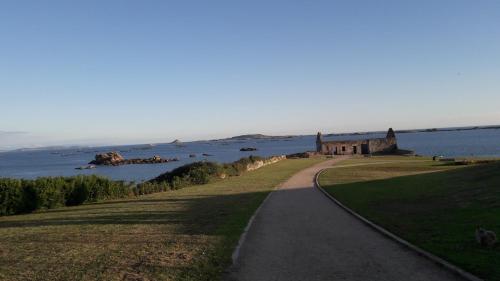 a path leading to an old castle in the water at Mirador Islas de Arousa in Ribeira