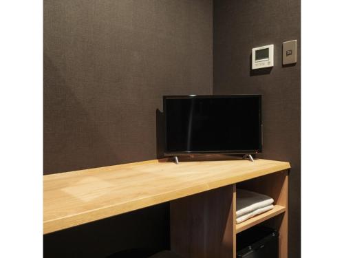 a desk with a television on top of it at 9 C Hotel Asahikawa - Vacation STAY 58446v in Asahikawa
