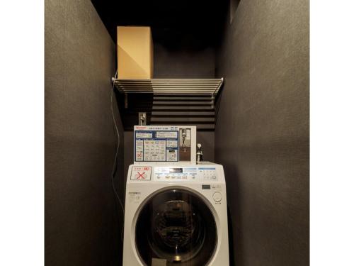 a washer and dryer in a corner of a room at 9 C Hotel Asahikawa - Vacation STAY 58441v in Asahikawa