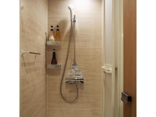 a shower with a shower head in a bathroom at 9 C Hotel Asahikawa - Vacation STAY 58446v in Asahikawa