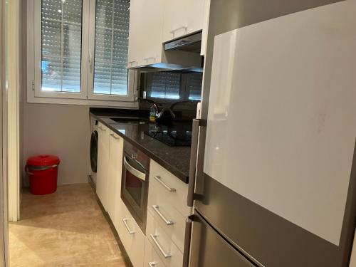 a kitchen with a refrigerator and a stove at APARTAMENTO CALLE CURIA 6 in Pamplona