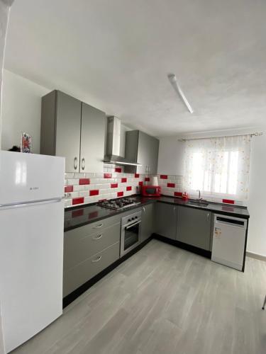 a kitchen with white appliances and a white refrigerator at Casa MIJAS PUEBLO La Villa Nueva in Mijas