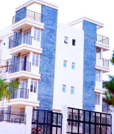 a tall building with blue and white at Sandib comfy homes in Kampala