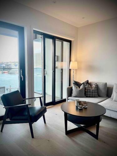a living room with a couch and a coffee table at Vervet apartment in Tromsø