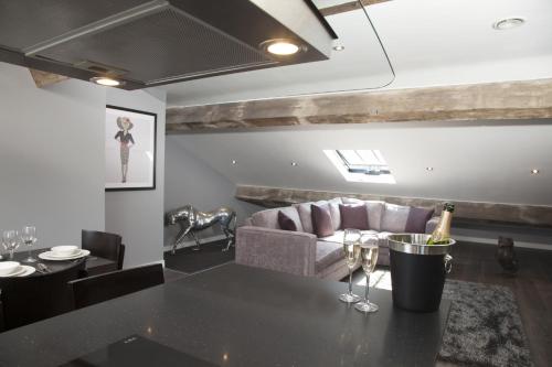 a living room with a couch and a table with wine glasses at EPIC Apart Hotel - Duke Street in Liverpool