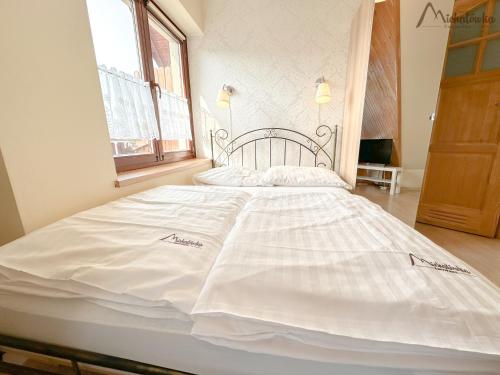 Postel nebo postele na pokoji v ubytování Willa Michałówka Attic