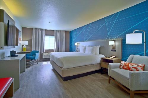 a large hotel room with a bed and a chair at Comfort Inn & Suites Sierra Vista near Ft Huachuca in Sierra Vista