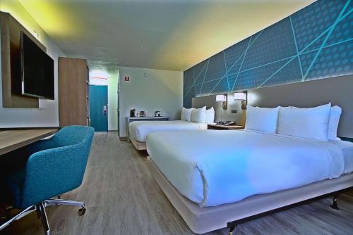 a large hotel room with two beds and a desk at Comfort Inn & Suites Sierra Vista near Ft Huachuca in Sierra Vista