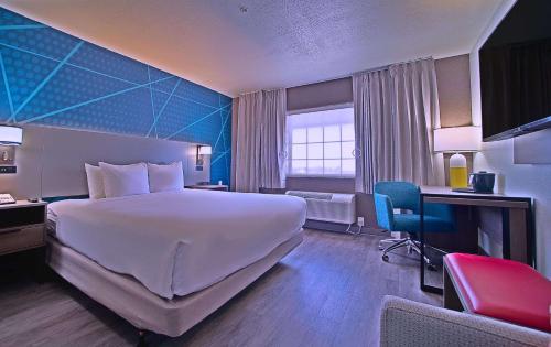 a hotel room with a large bed and a desk at Comfort Inn & Suites Sierra Vista near Ft Huachuca in Sierra Vista