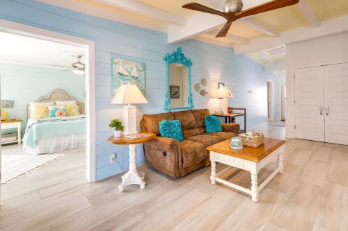 a living room with a couch and a table at Pet-Friendly Jekyll Island Abode - Walk to Beach! in Jekyll Island