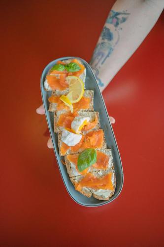 a person holding a tray of food on a table at Best Western Linko Aubagne in Aubagne