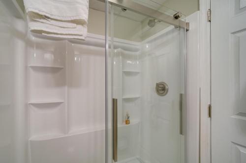 a shower with a glass door in a bathroom at Stylish Gatlinburg Condo with Pool Walk Downtown! in Gatlinburg