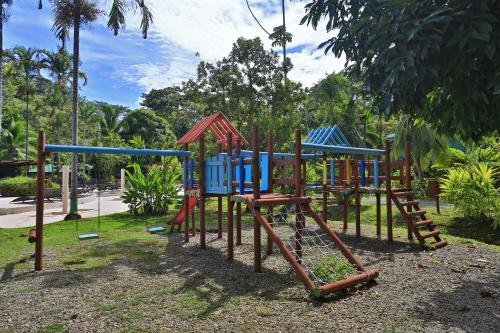 a playground in a park with a blue and red equipment at Manzanillo Caribbean Resort in Puerto Viejo