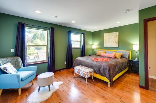 a bedroom with green walls and a bed and a blue chair at Waterfront Birch Bay Rental - Walk to Beach! in Blaine