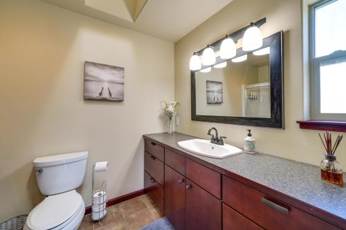 a bathroom with a toilet and a sink and a mirror at Waterfront Birch Bay Rental - Walk to Beach! in Blaine