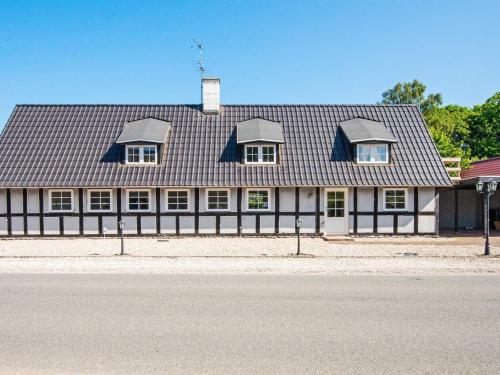 a black and white building with a roof at 10 person holiday home in Auning-By Traum in Auning