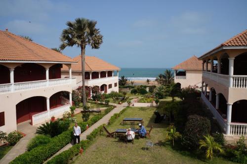 a group of people standing outside of a building at Lemon Creek Hotel Resort in Bijilo