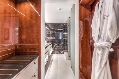una cocina con armarios blancos y un pasillo largo en AZUR Legacy Collection Hotel en Vancouver
