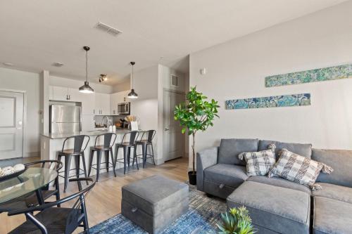 a living room and kitchen with a couch and a table at Luxury Condo in Ybor City Tampa w/Pool access in Tampa